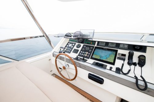 Captain’s helm with steering wheel and navigation controls on Starlink yacht