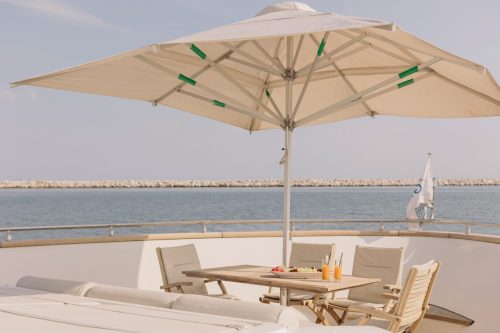 Sun deck with dining table and elegant decoration on Starlink yacht